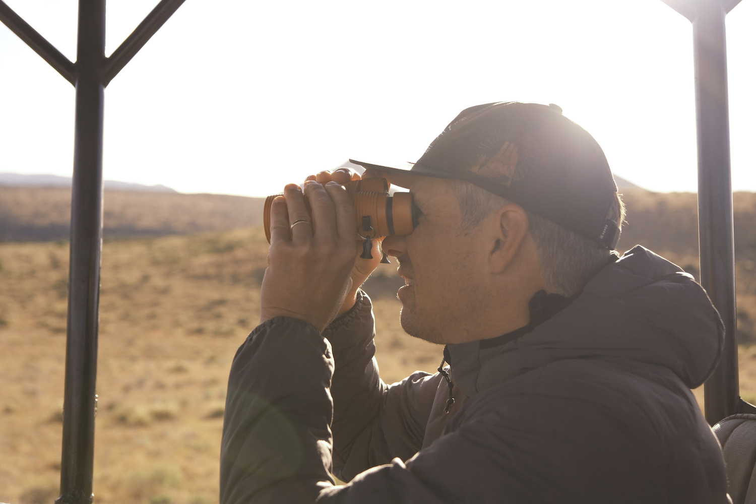 A man holding a pair of binoculars.
