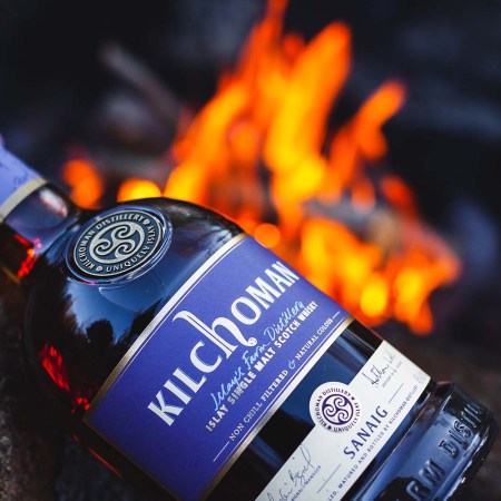 Kilchoman Sanaig bottle in front of a fire