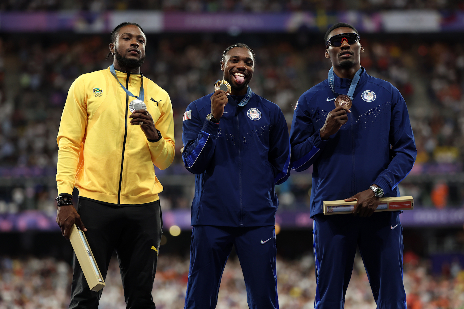 The top three medalists in the 100m dash at the Pairs Games.