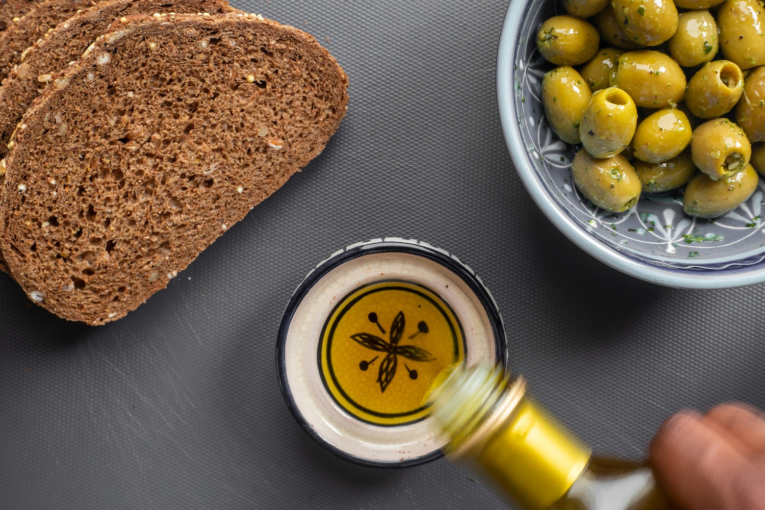 Bread, olive oil and olives on a table