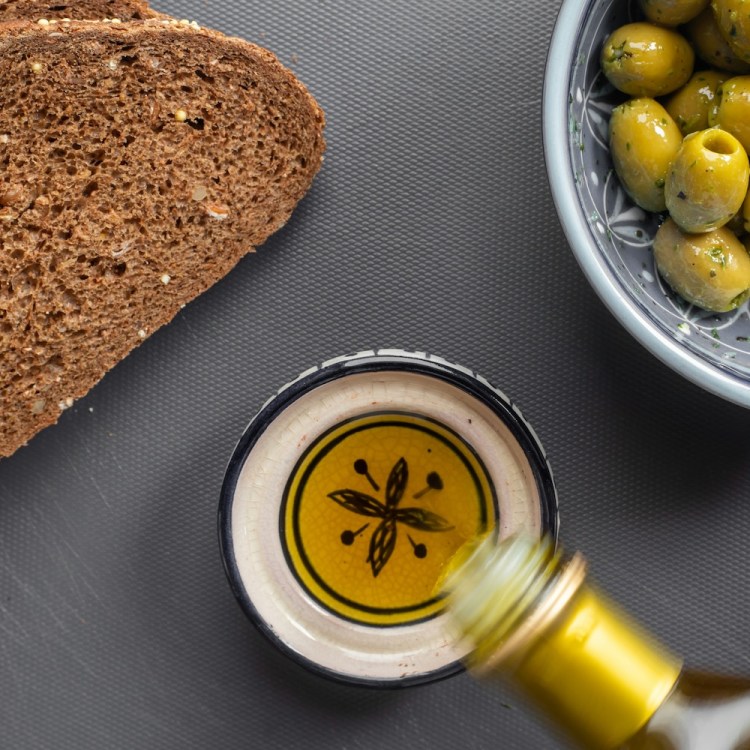 Bread, olive oil and olives on a table