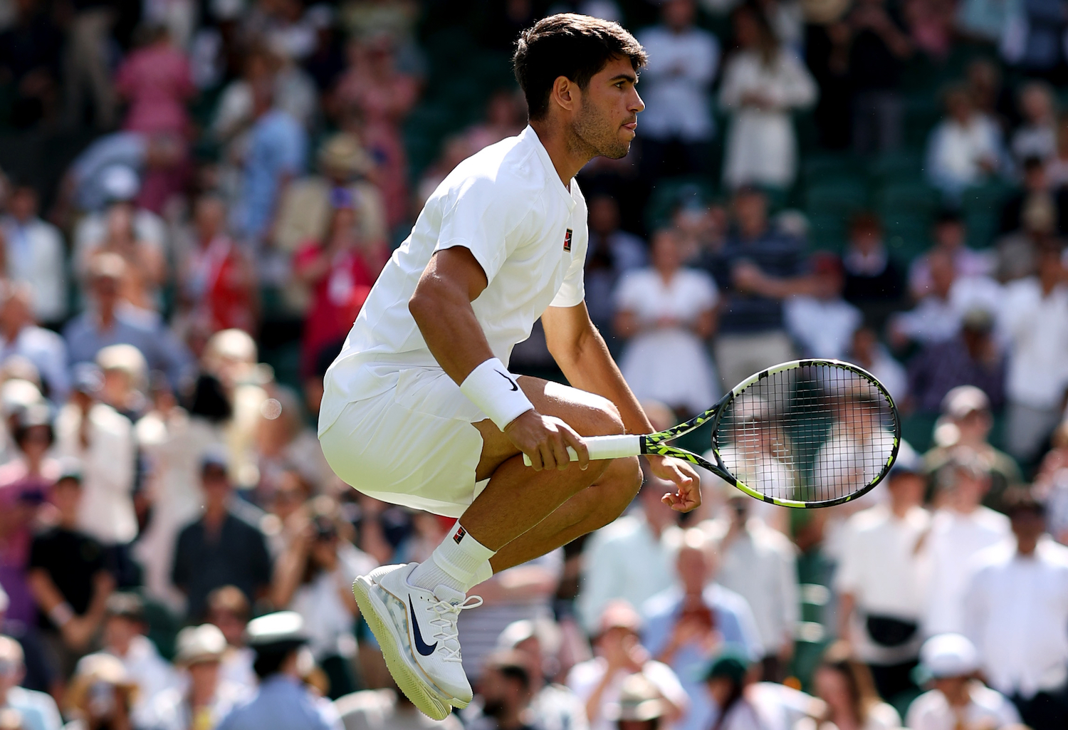 A photo of Carlos Alcaraz jumping up and down at Wimbledon.