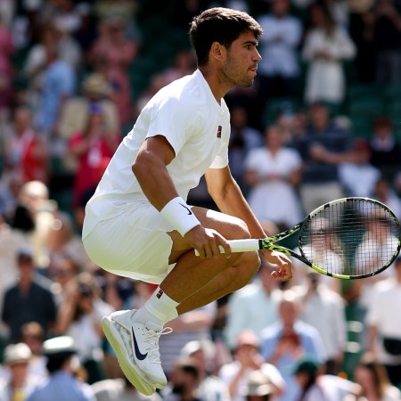A photo of Carlos Alcaraz jumping up and down at Wimbledon.