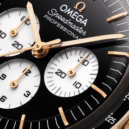 One of the new Omega Speedmaster Moonwatch Professional watches with a black and white reverse panda dial, this model is gold while the other is stainless steel
