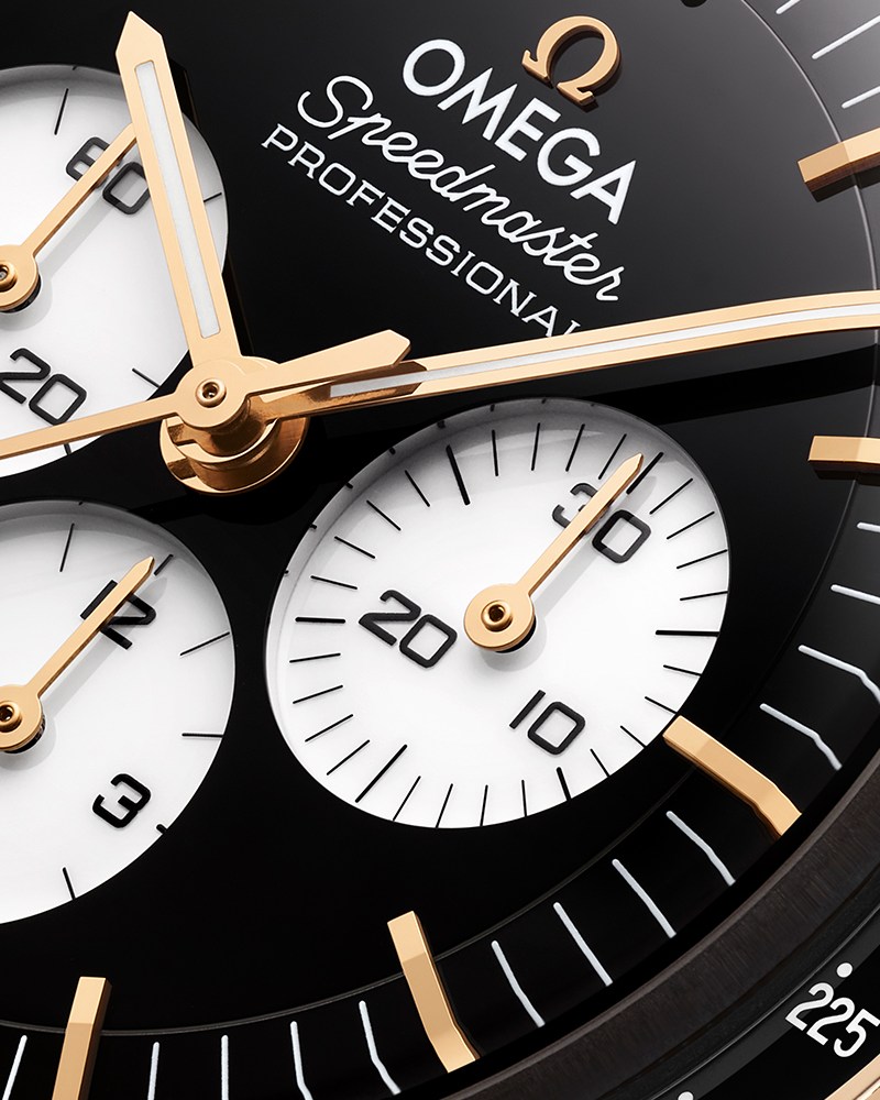 One of the new Omega Speedmaster Moonwatch Professional watches with a black and white reverse panda dial, this model is gold while the other is stainless steel