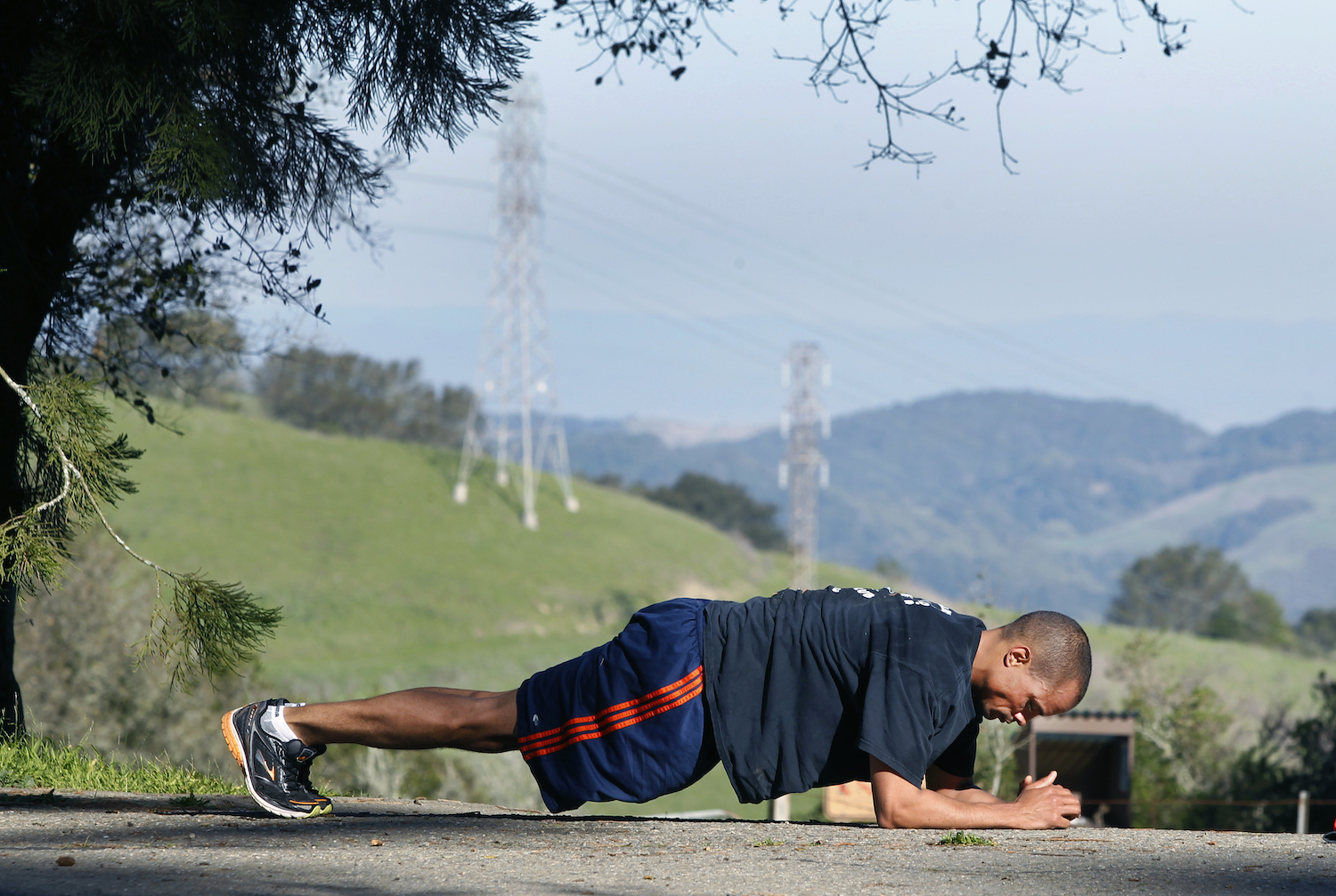 A man doing a plank outside.