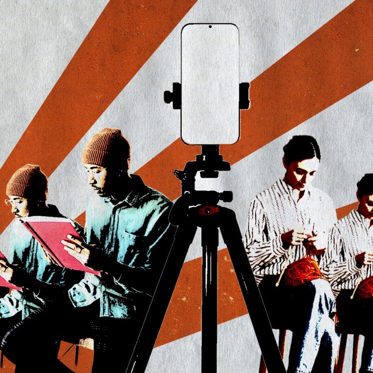 Person sitting reading a book and a person crocheting with a phone on a tripod in the midda