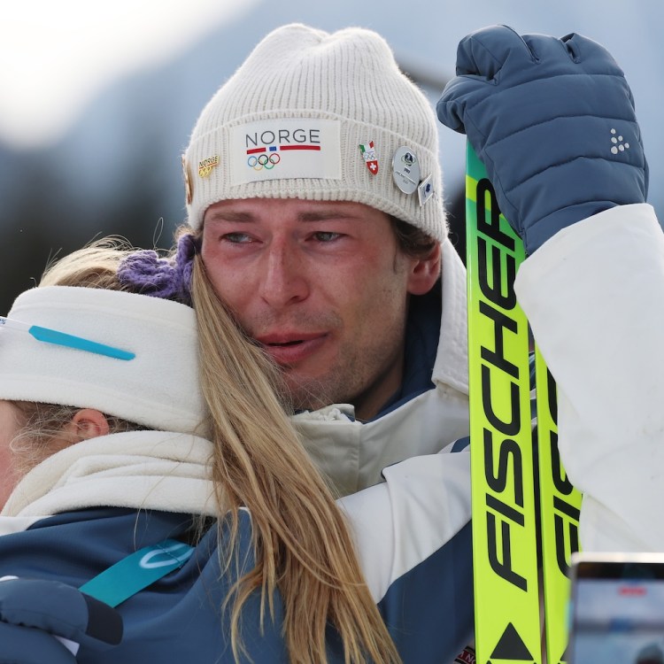Bronze medalist Sturla Holm Laegreid of Team Norway is embraced by Ingrid Landmark Tandrevold of Team Norway after the medal ceremony
