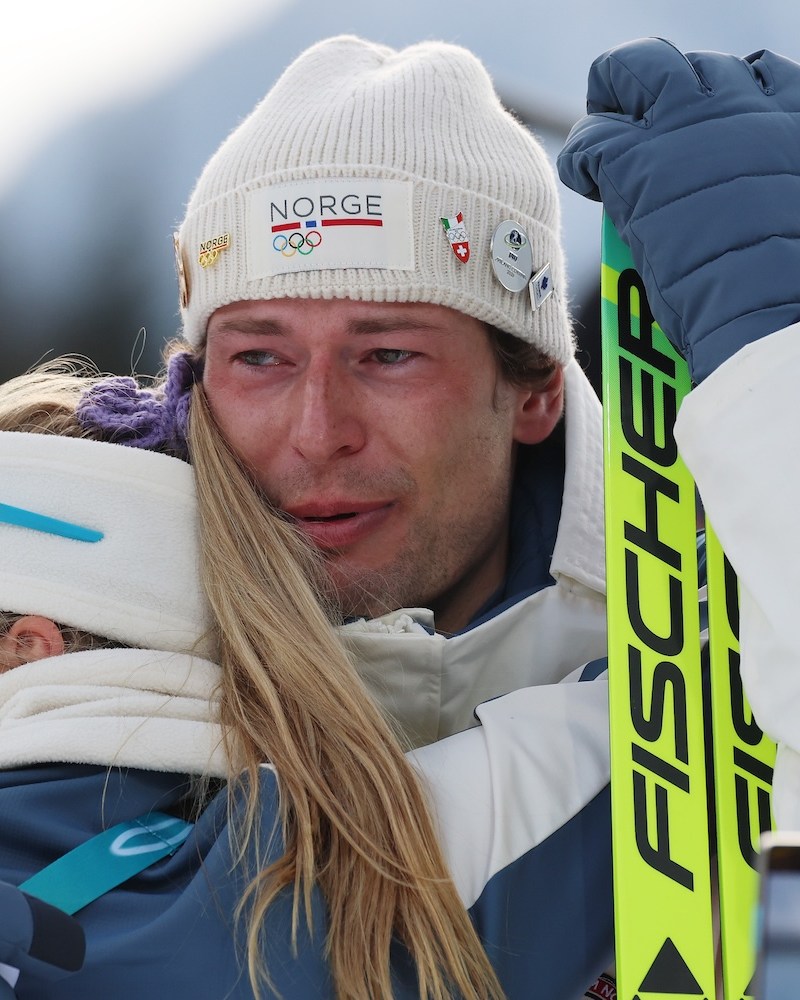 Bronze medalist Sturla Holm Laegreid of Team Norway is embraced by Ingrid Landmark Tandrevold of Team Norway after the medal ceremony