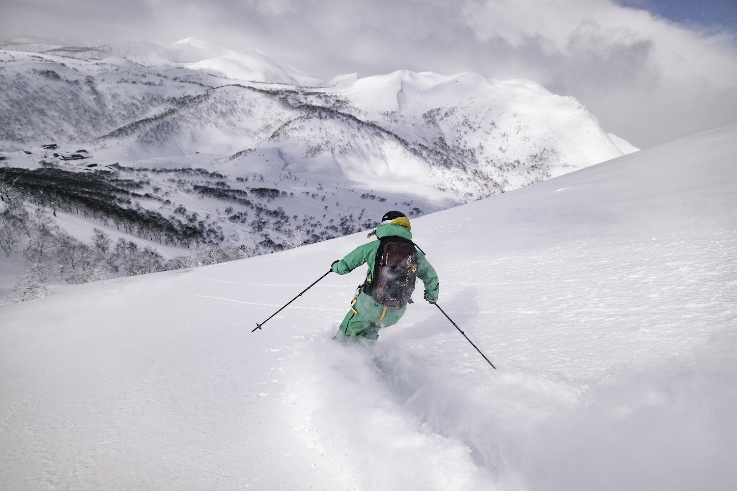 A skier carving through powder in Hokkaido.