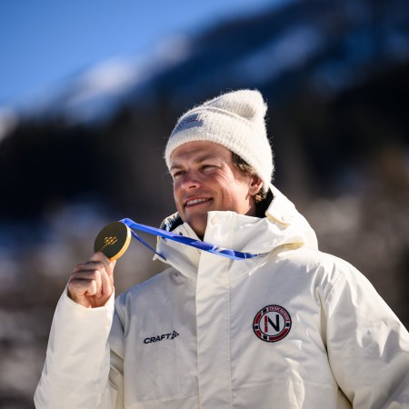 Johannes Høsflot Klæbo holding a gold medal.