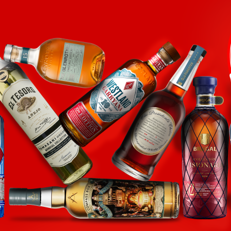 liquor bottles stacked on a red background