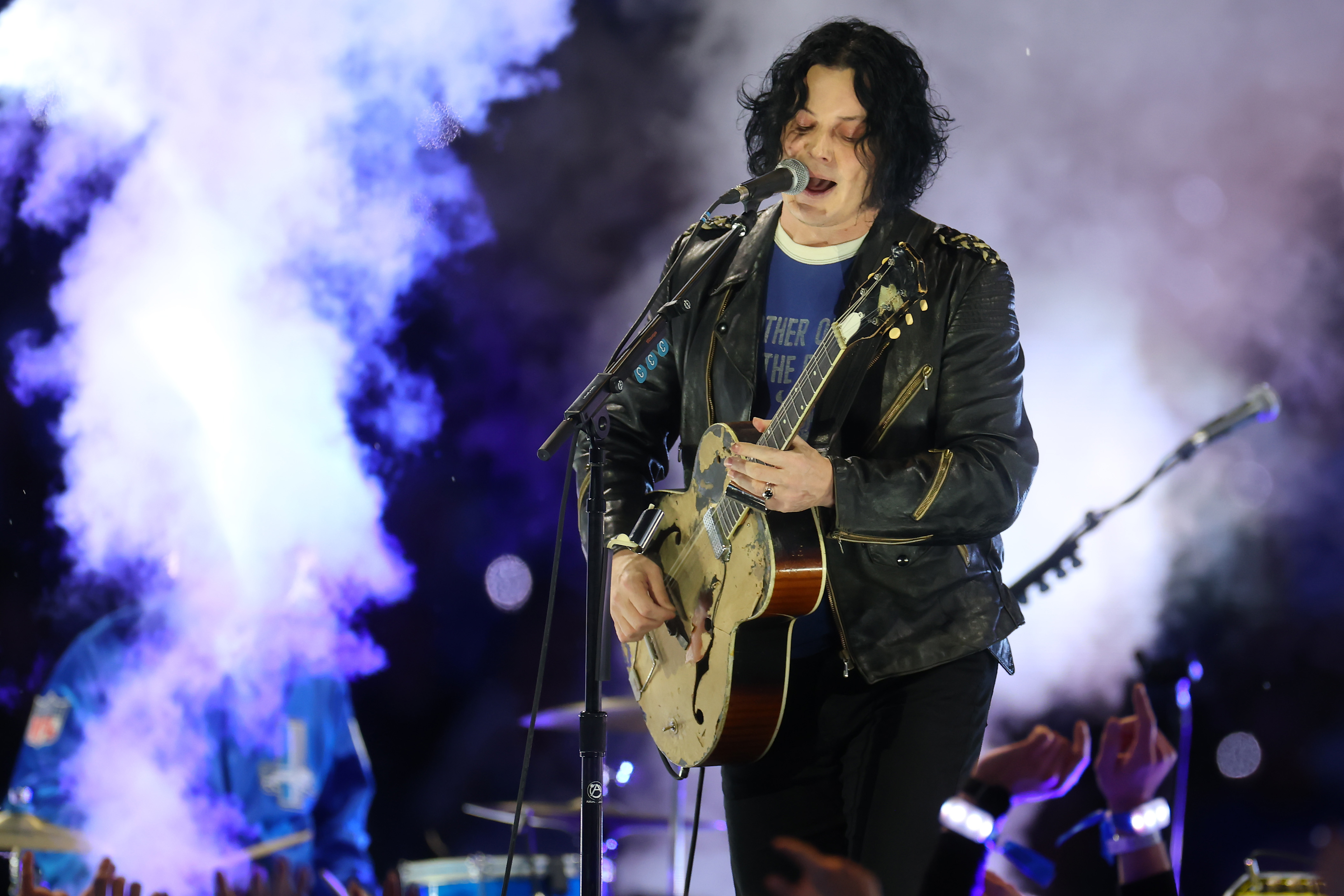 Jack White playing guitar at a concert. He recently said in an interview that he finds autobiographical songwriting "boring."