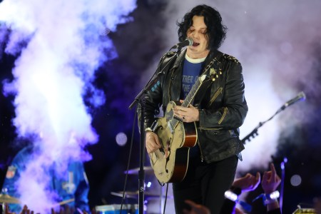 Jack White playing guitar at a concert. He recently said in an interview that he finds autobiographical songwriting "boring."
