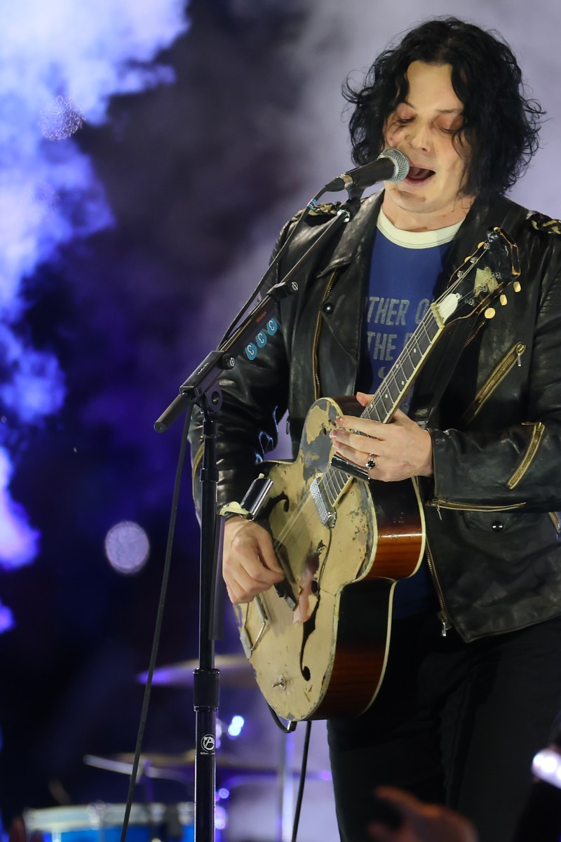 Jack White playing guitar at a concert. He recently said in an interview that he finds autobiographical songwriting "boring."