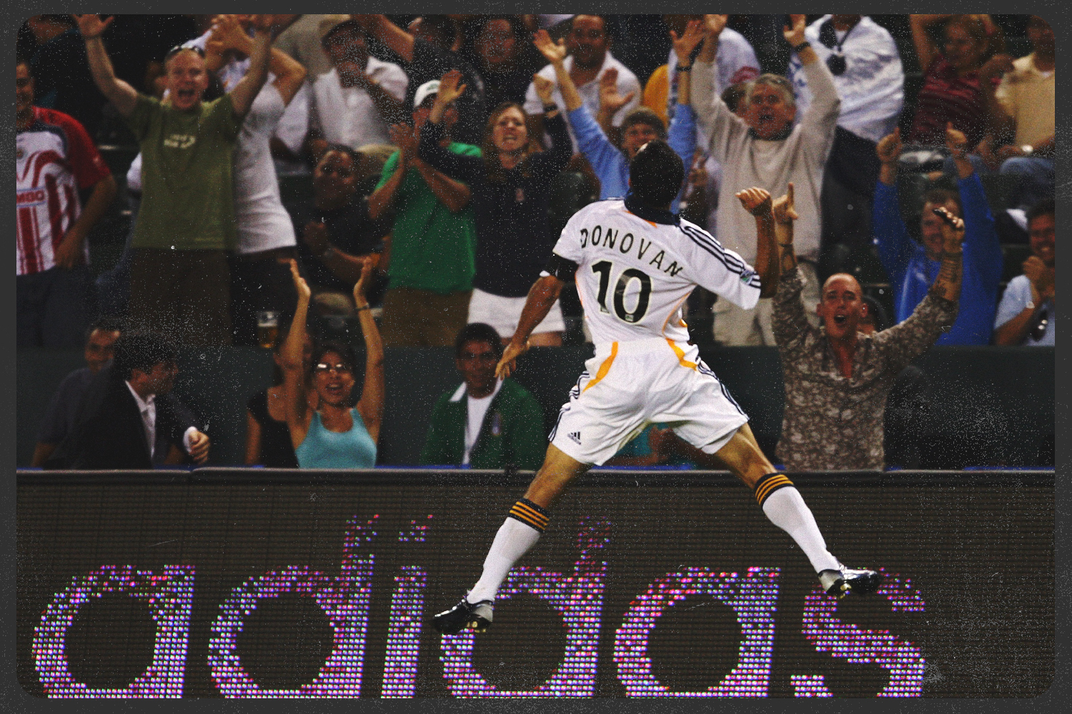 Donovan leaps in front of the crowd, one hand raised in the air.