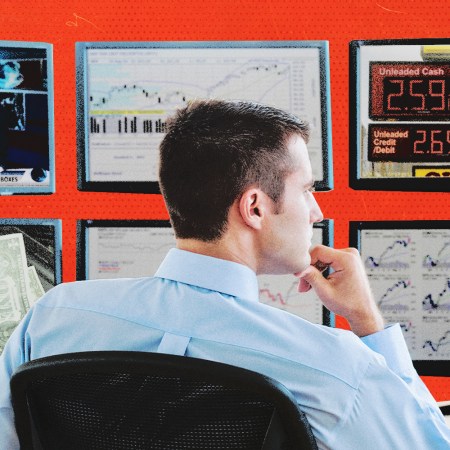 A man analyzing multiple screens with news and charts