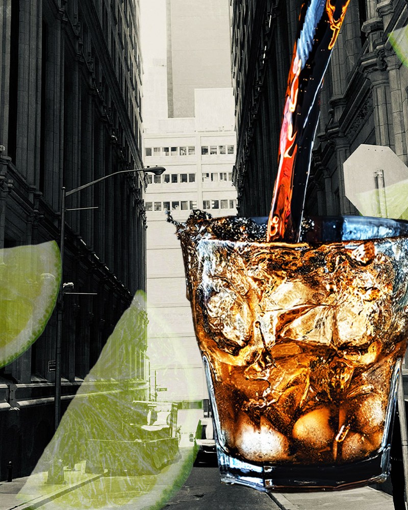A rum and coke, limes and a city skyline