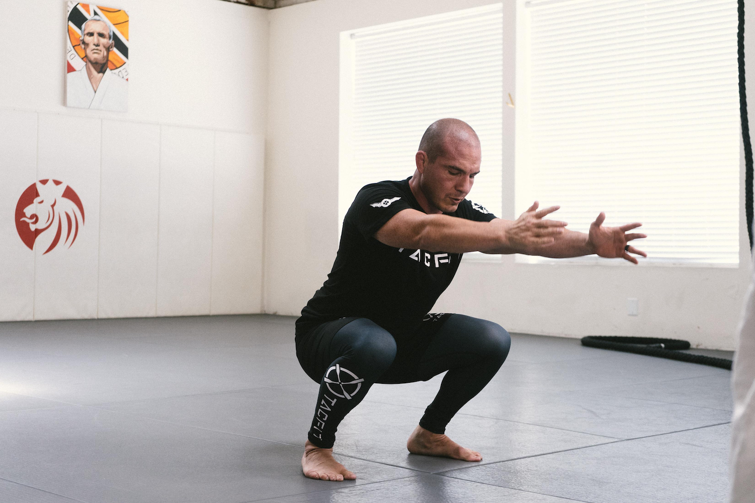 Alberto Crane in a deep squat.
