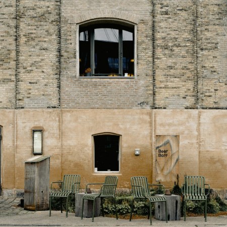 Outside Noma's original location: a brick building with windows and chairs
