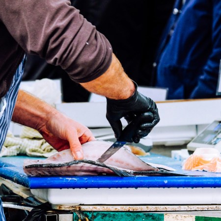 A man cutting a fish.