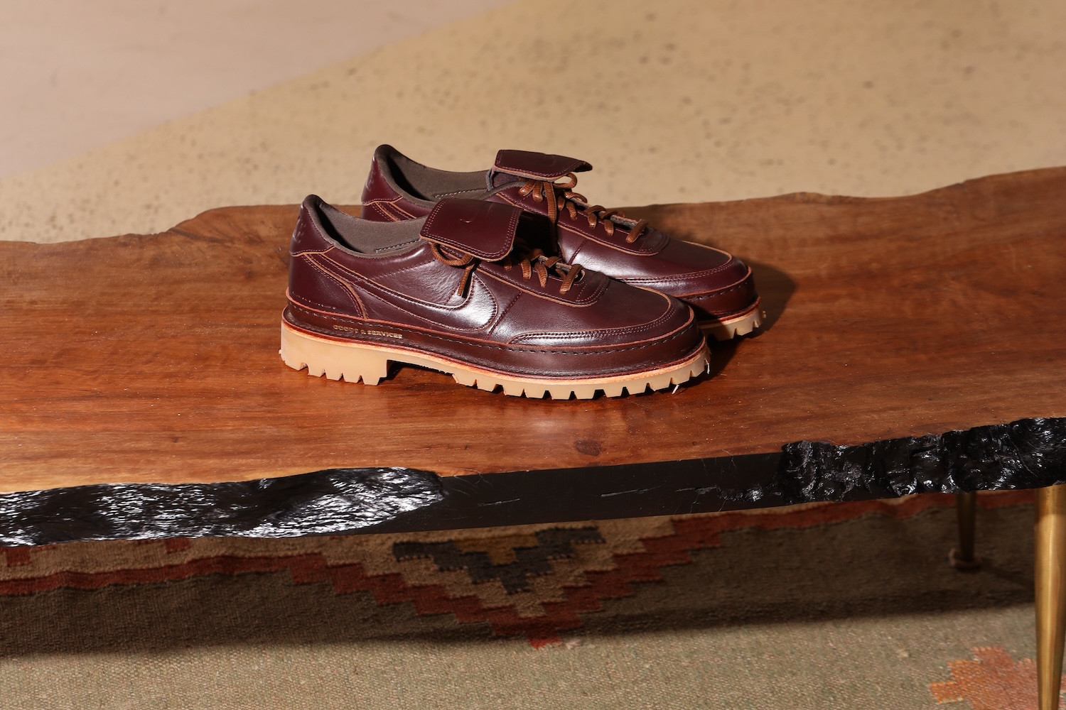 A pair of brown shoes sitting on a wooden bench