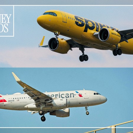 A Spirit Airlines plane and an American Airlines plane flying in the sky.