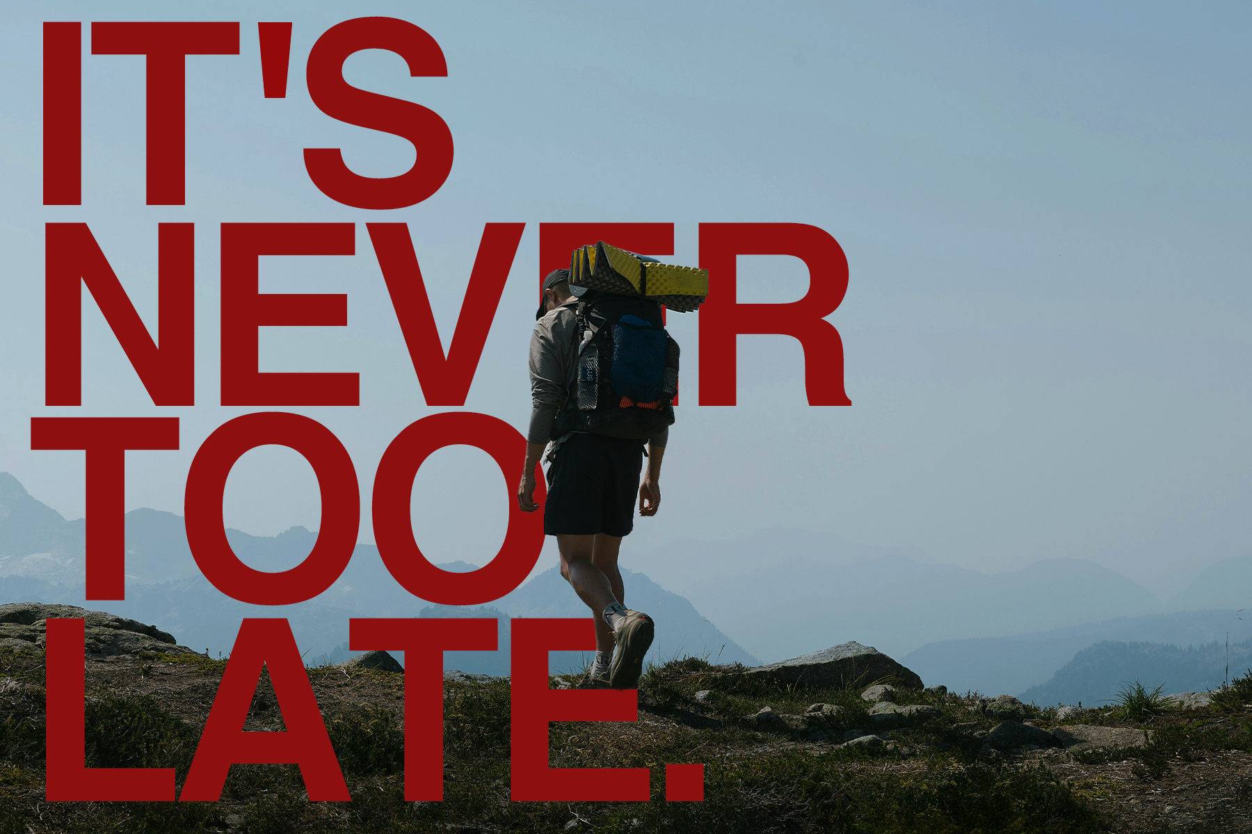 A man rucking on a trail with a backpack filled with weights. Over top, there is text that reads: It's Never Too Late.