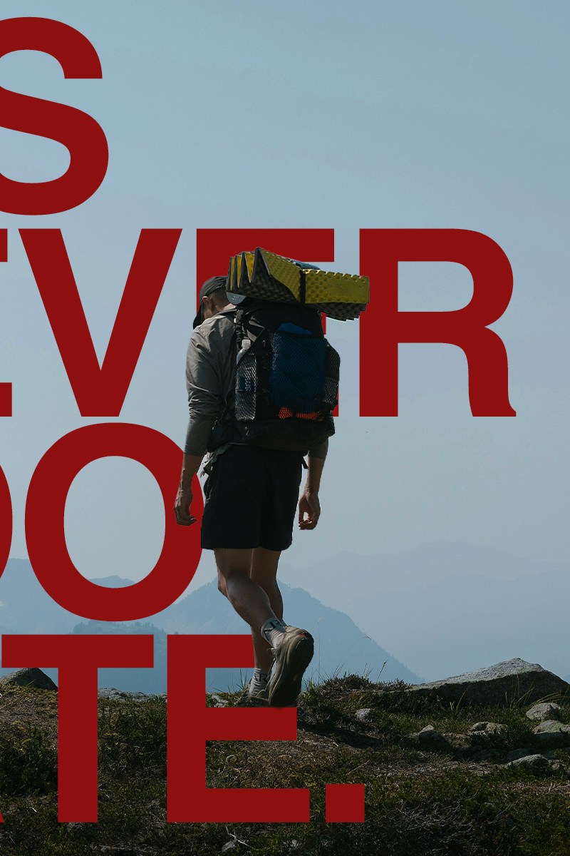 A man rucking on a trail with a backpack filled with weights. Over top, there is text that reads: It's Never Too Late.