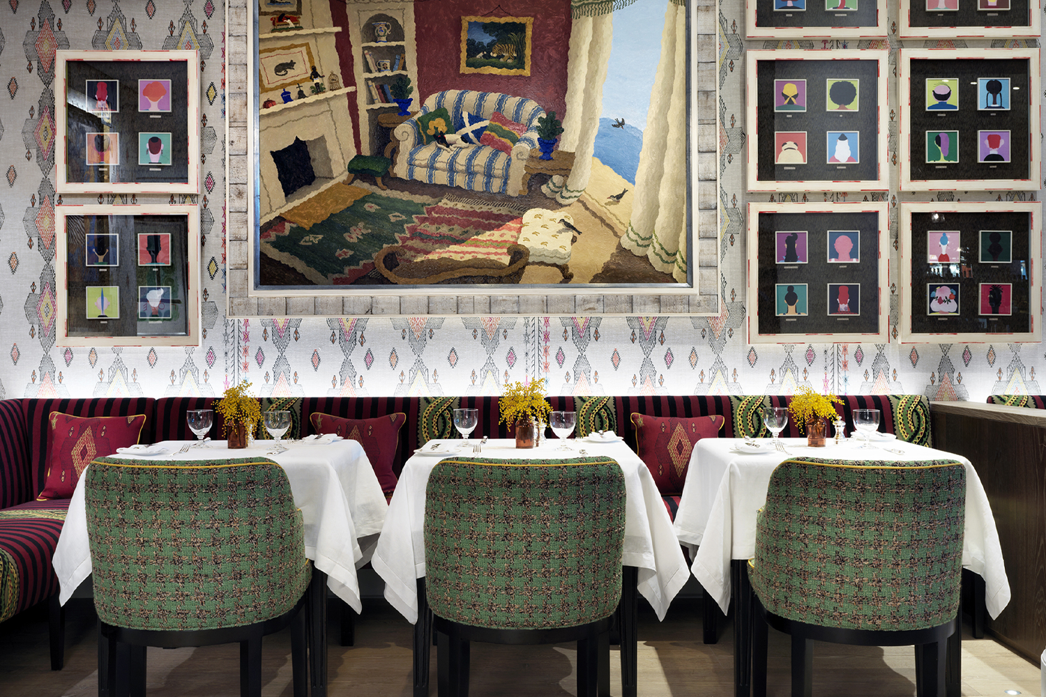 Dining room at The Whitby Hotel featuring colorful patterned seating, eclectic artwork, statement lighting and a lively, design-forward atmosphere set for guests.