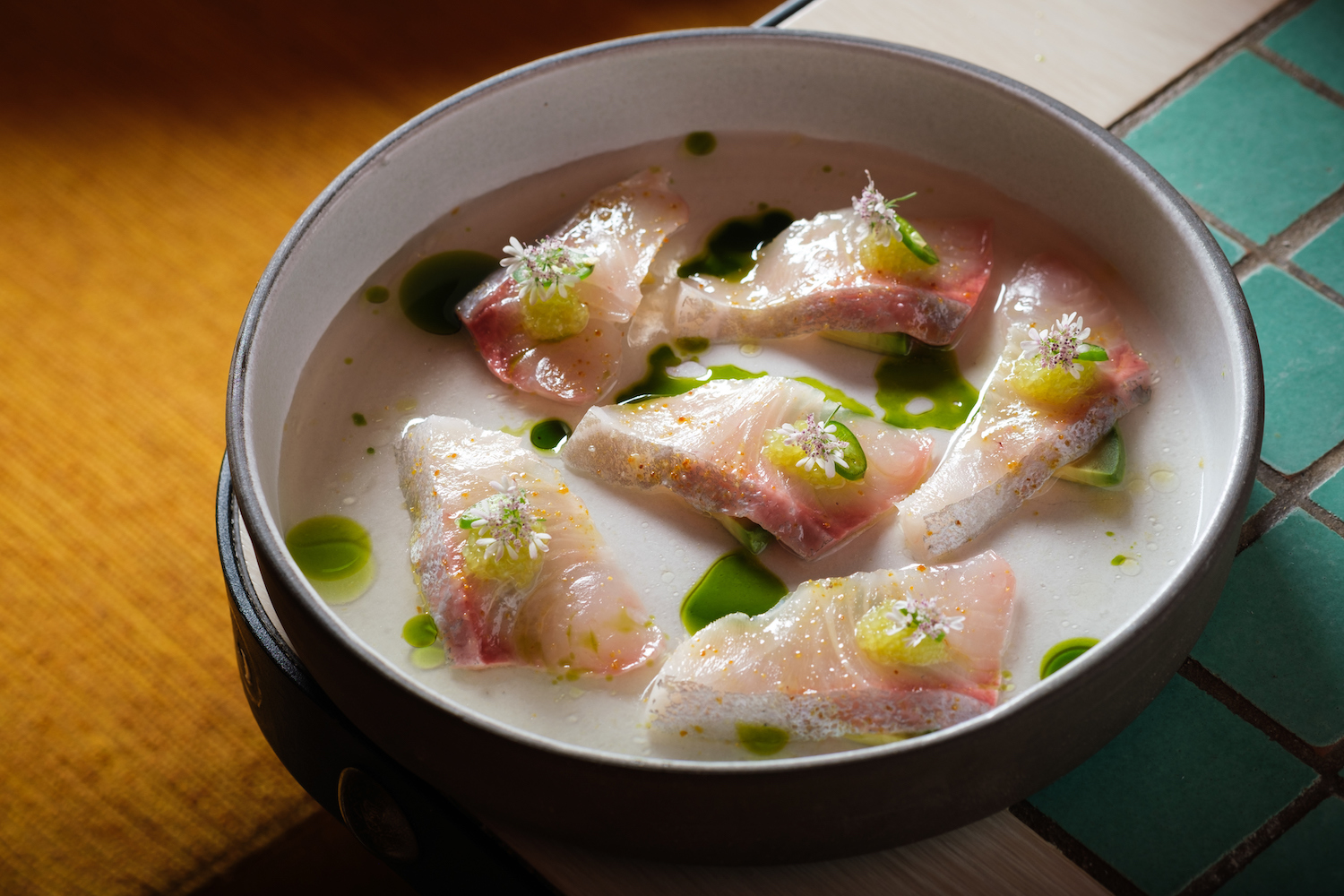 Kanpachi with tomato dashi, charred avocado and finger lime at Casa Playa