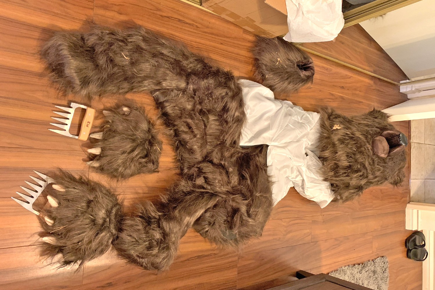 Bear costume on a wood floor