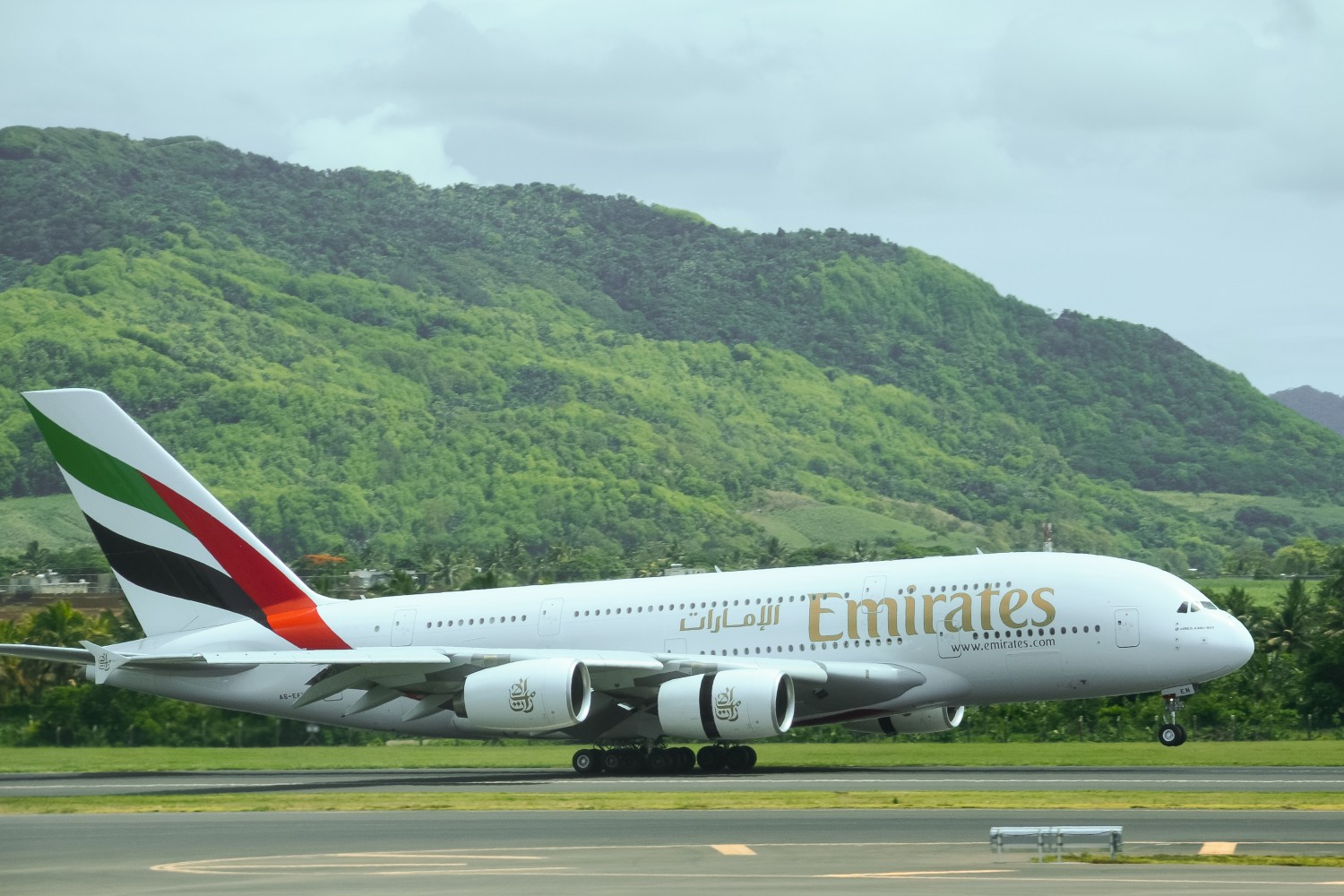 Emirates flight landing against a green background