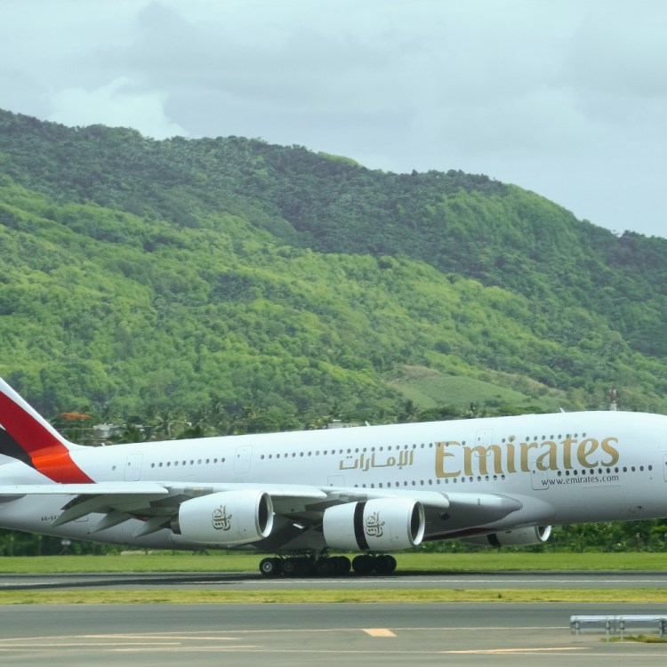 Emirates flight landing against a green background