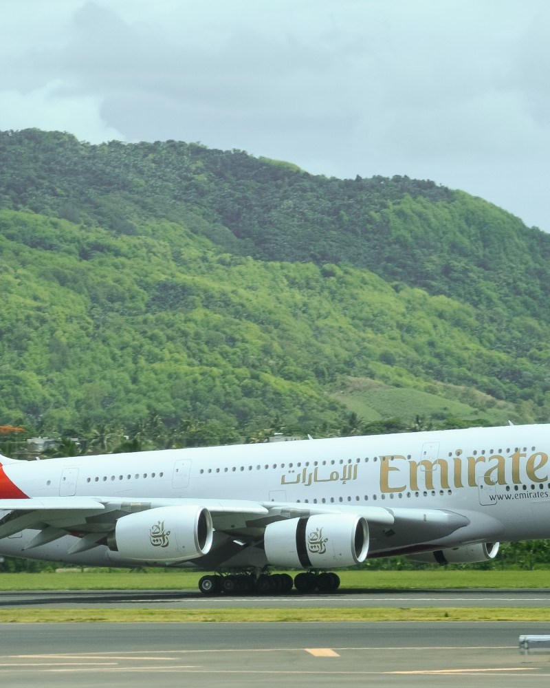 Emirates flight landing against a green background