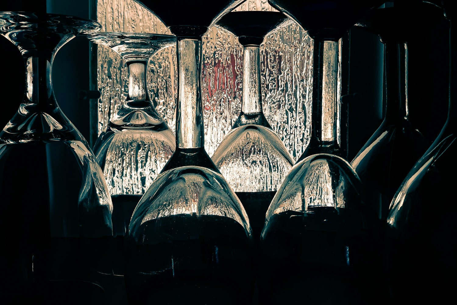 Empty wine glasses with a rainy window in the background