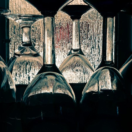 Empty wine glasses with a rainy window in the background