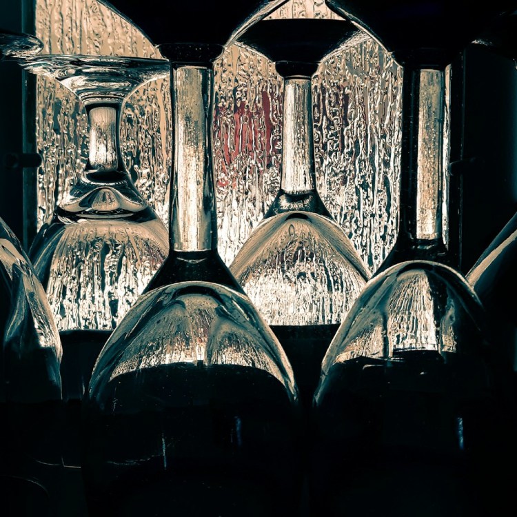 Empty wine glasses with a rainy window in the background
