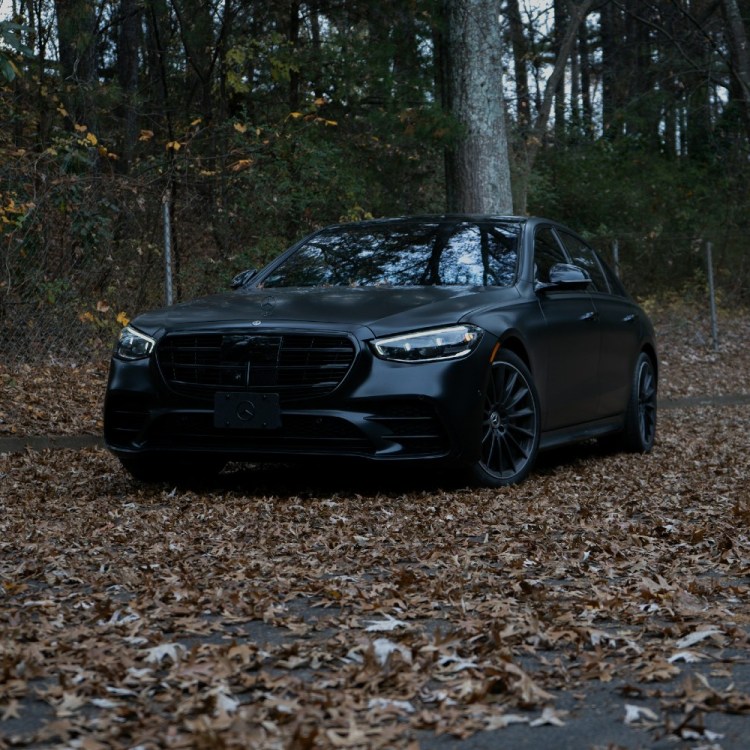 Luxury car surrounded by fallen leaves