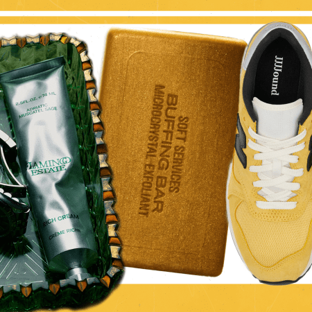 A glass tray with handcream on it, a golden bar of soap and yellow sneakers on a white and yellow background.