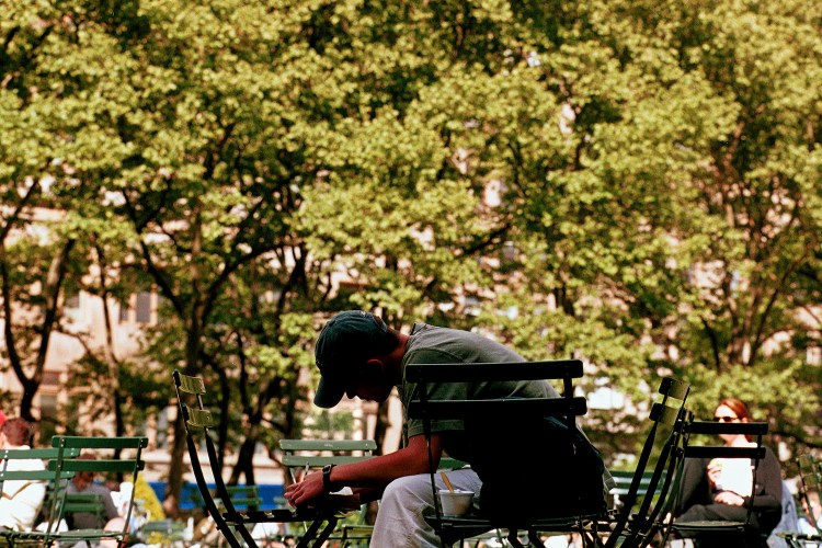 A man writing in the park