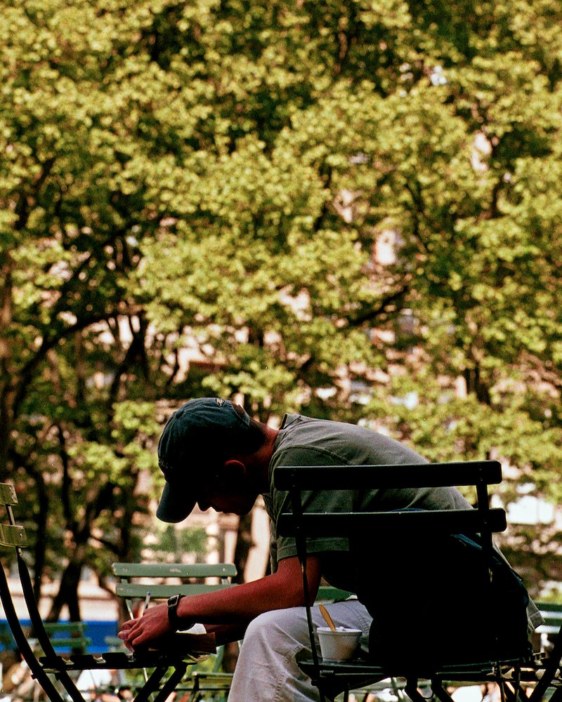 A man writing in the park
