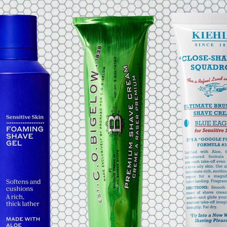 A blue bottle, a green tube and a white tube on a tile background