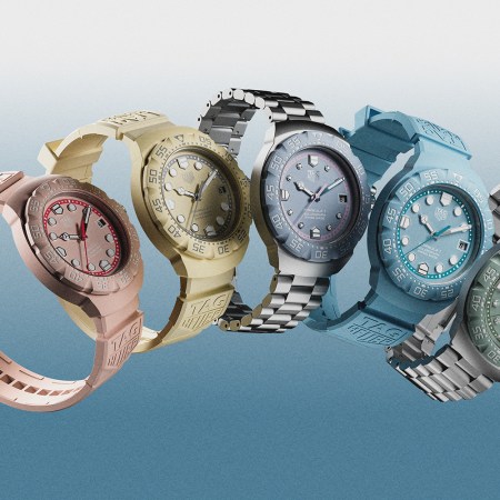 Five watches floating in the air in the colors pink, yellow, blue and green with a background that fades from white to blue