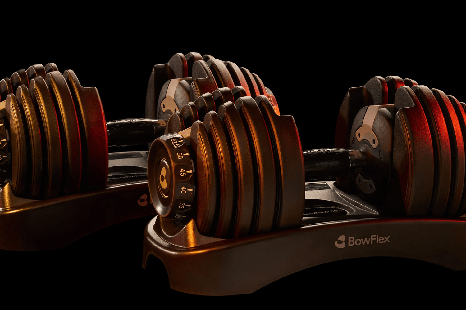 Lifestyle image of Bowflex dumbbells in low lighting