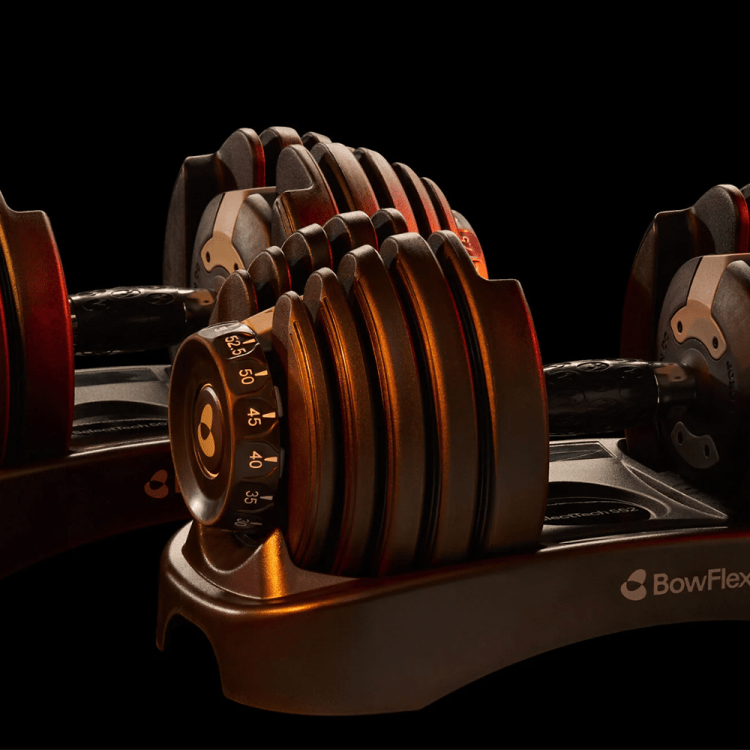 Lifestyle image of Bowflex dumbbells in low lighting