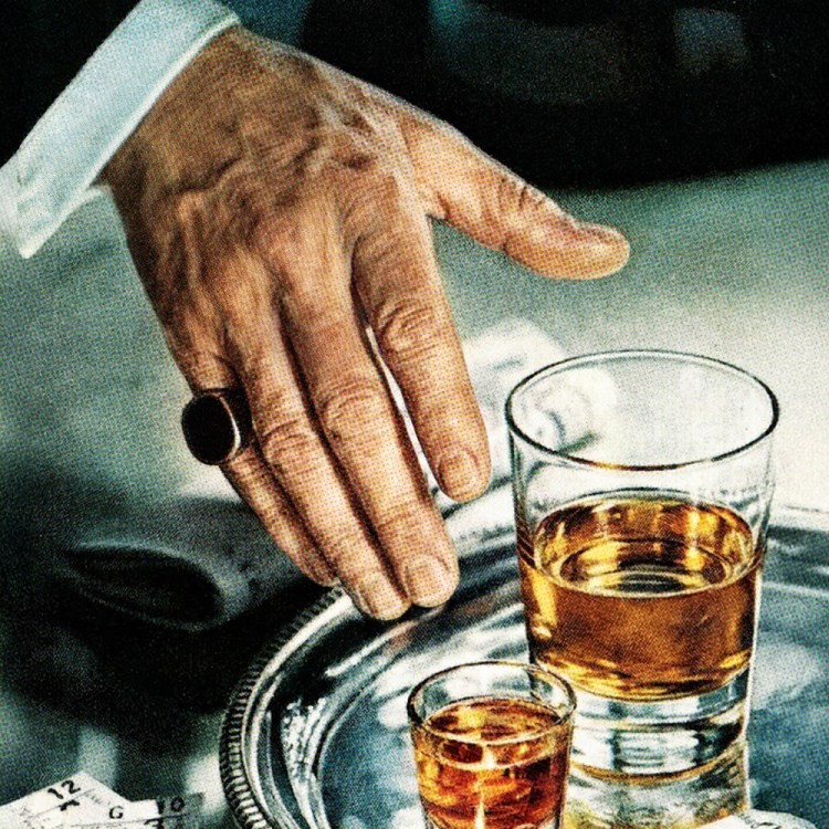 A man reaching for a glass of whiskey