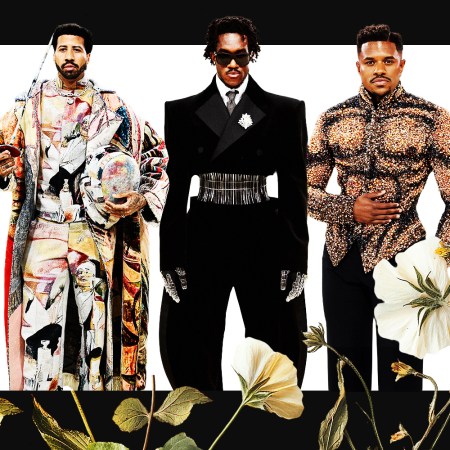 Three men in elaborate designer clothes standing in front of a white background surrounded by a black border with flowers growing up from the bottom