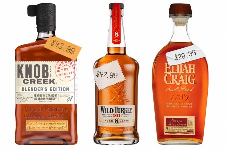 bottles of knob creek, wild turkey 101 8 year and elijah craig small batch lined up on a white background