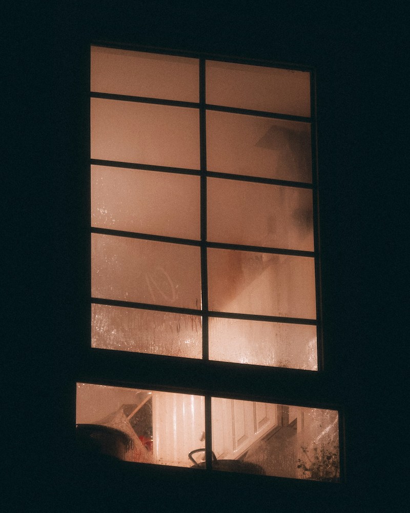 A bedroom window at night.